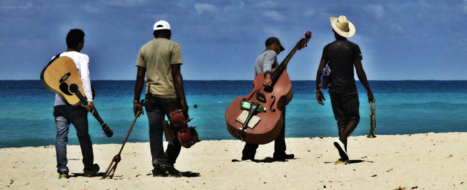 musicians walking along Havana beach